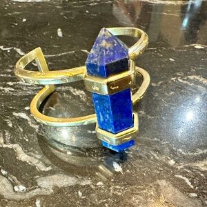 Kendra Scott Bangle Bracelet in Gold with a Blue Stone. It measures at 6"w 2.5"h